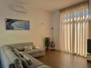 a living room with a couch and a television at Apt. Aquarius Oasi di Menaggio in Menaggio