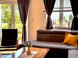 a living room with a couch and a table at Holiday home Melani - with private heated pool and sauna in Sinac