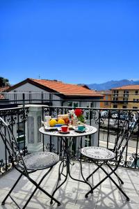 a table with a bowl of fruit on a balcony at Apt. Aquarius Oasi di Menaggio in Menaggio