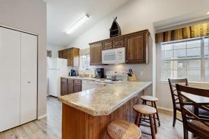 a kitchen with wooden cabinets and white appliances at Lantern Bay Retreat in Branson