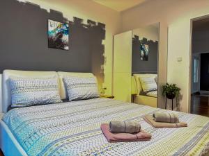 a large bed with two towels on top of it at Holiday home Melani - with private heated pool and sauna in Sinac +38 photos