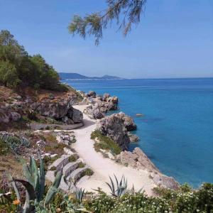 a beach with some rocks and the ocean at Cozy City Apartment - sleeps 2 in Rhodes Town