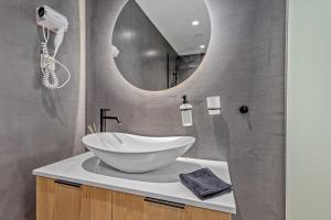 a bathroom with a sink and a mirror at Athens Theatrou Apartments in Athens