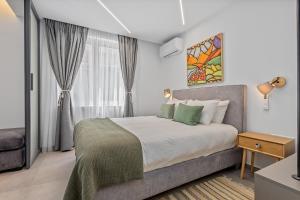 a bedroom with a large bed and a window at Athens Theatrou Apartments in Athens