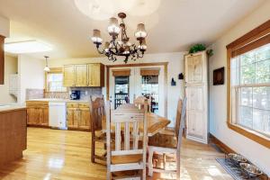 a kitchen with a table and chairs and a chandelier at Beautiful Branson in Branson West
