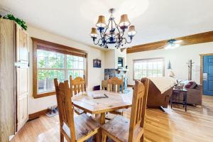 a dining room and living room with a table and chairs at Beautiful Branson in Branson West