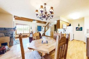 a kitchen and living room with a wooden table and chairs at Beautiful Branson in Branson West
