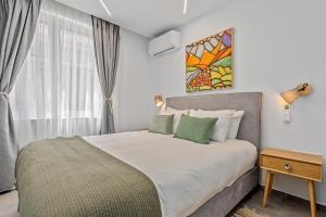a bedroom with a large bed and a window at Athens Theatrou Apartments in Athens