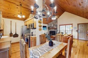 a kitchen and dining room with a table and chairs at Woodland in Branson West