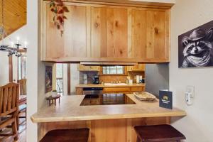 a kitchen with wooden cabinets and a counter top at Woodland in Branson West