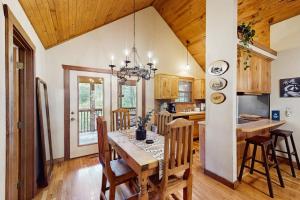a dining room and kitchen with a table and chairs at Woodland in Branson West