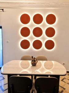 a table with chairs in front of a wall with circles at Kaz An Nou in Kika +6 photos