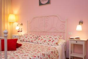 a bedroom with a white bed with a red pillow at Malkavacanze B&B in Rome
