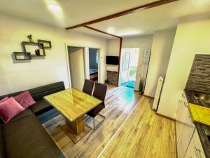 a living room with a couch and a table at Apartment Gacka in Otočac