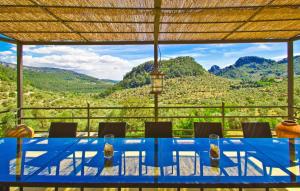a blue table with chairs and a view of mountains at Biniforani Nou in Bunyola