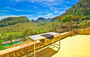 a table on a patio with a view of a mountain at Biniforani Nou in Bunyola