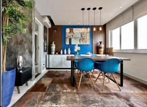 a dining room with a table and blue chairs at Best 2 bedroom condo 3 bathroom in Rio de Janeiro
