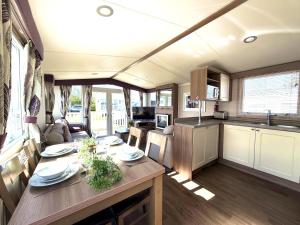 a kitchen and dining room with a table in an rv at Primrose View in Filey