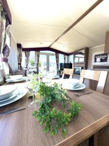 a dining room with a table with plates and glasses at Primrose View in Filey