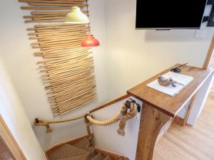 a room with a desk and a television and a table at Redwood in Harlech