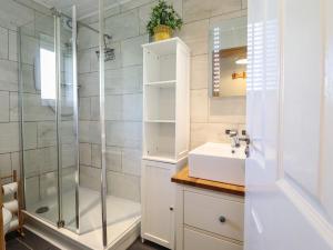 a bathroom with a shower and a sink at Redwood in Harlech +26 photos