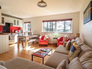 a living room with a couch and a table at Redwood in Harlech