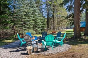 a group of chairs sitting around a table in a yard at Glacier Cabins in Martin City +70 photos