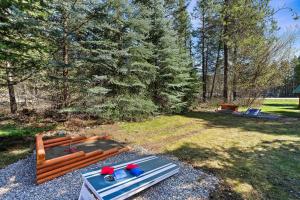 a wooden bed in a yard with a table at Glacier Cabins in Martin City