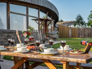 a wooden table with food and wine glasses on it at 3 Bed in Kinross oc-55935 in Kinross
