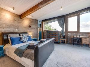 a bedroom with a large bed and a table and chairs at 3 Bed in Kinross oc-55935 in Kinross