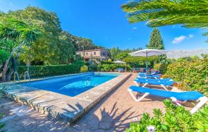 a pool with lounge chairs and umbrellas in a resort at Ca Les Estamenyes in Pollença +44 photos