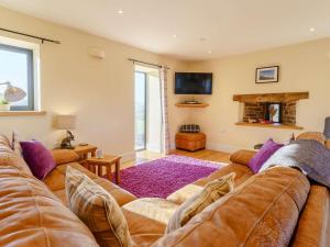 a living room with a couch and a fireplace at 3 Bed in Crickhowell oc-90757 in Cwm-du