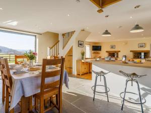 a kitchen and dining room with a table and chairs at 3 Bed in Crickhowell oc-90757 in Cwm-du