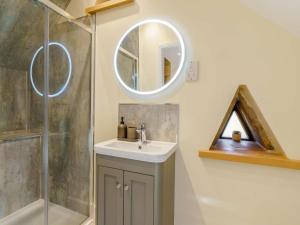 a bathroom with a sink and a mirror at 3 Bed in Crickhowell oc-90757 in Cwm-du +28 photos
