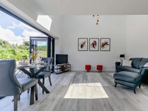 a living room with a table and chairs and a tv at 1 Bed in Redruth oc-92281 in Redruth