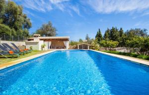 a pool with blue water in front of a house at Ca Na Rosa De Selva in El Port de la Selva