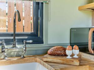 a kitchen counter with a sink and eggs on a cutting board at 1 Bed in Hawarden oc-93595 in Hawarden