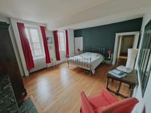 a living room with a bed and a table at Gîte De Charme - La Mésangerie in Saint-Satur +21 photos