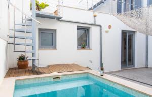 a house with a swimming pool next to a house at Petit Arta - Sa Botigueta in Artá
