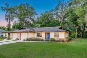 a house with a yard with a house at Blue Spring Getaway with Fire Pit in Orange City +24 photos