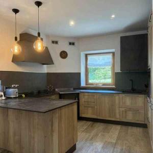 a kitchen with wooden cabinets and a window at Chalet in Pieve di Ledro-Ledrosee 57751 in Pieve Di Ledro