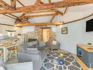 a living room with a couch and a table at 2 Bed in Bideford oc-60765 in Buckland Brewer