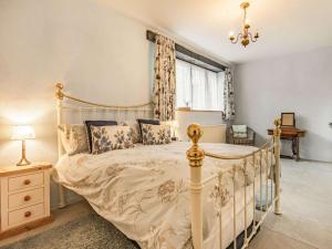 a bedroom with a bed and a window at 2 Bed in Bideford oc-60765 in Buckland Brewer