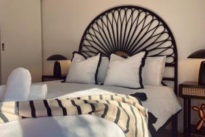 a bedroom with a large bed with a large headboard at The Newton in Lyons