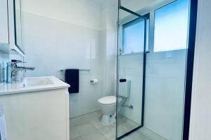 a bathroom with a shower and a toilet and a sink at The Newton in Lyons