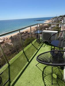 a balcony with a table and chairs and the beach at Kabakum See infinity in Varna City