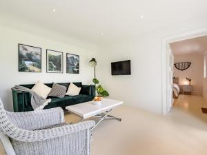 a living room with a green couch and chairs at 1 Bed in Manningtree oc-78389 in Lawford +7 photos
