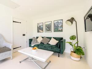 a living room with a green couch and a table at 1 Bed in Manningtree oc-78389 in Lawford