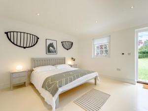 a white bedroom with a bed and a window at 1 Bed in Manningtree oc-78389 in Lawford