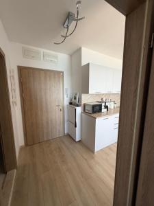 a kitchen with a door and a kitchen with a counter at Kabakum See infinity in Varna City +13 photos